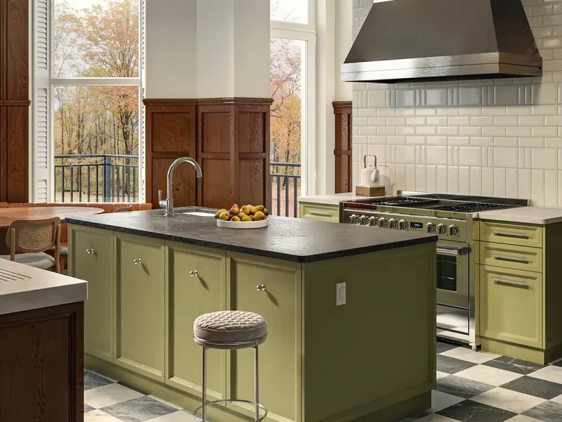 Kitchen island in green with a range, steel hood and brass pendants, rendered in 3D